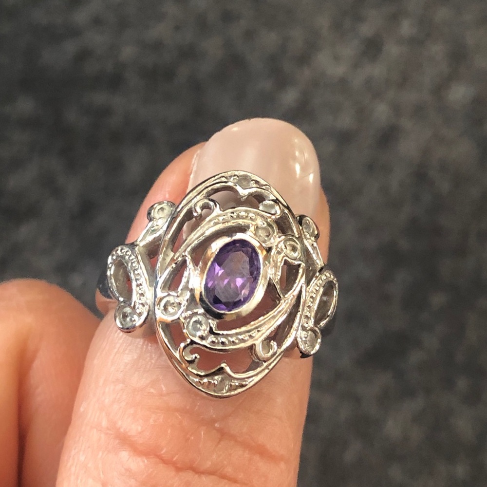 Silver tone ring with purple stone